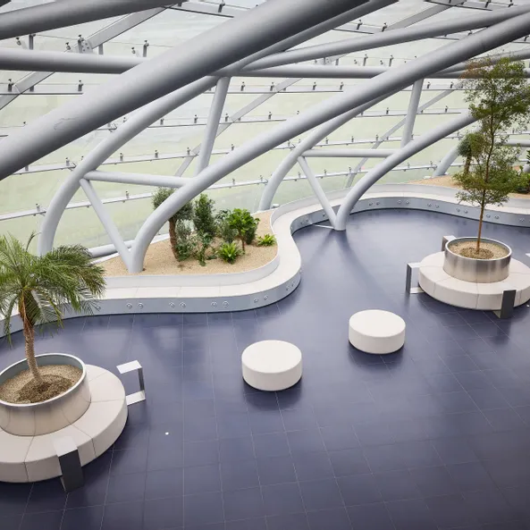 Interior view of Hangar-7 showing its glass-and-steel architecture, seating arrangements and plants